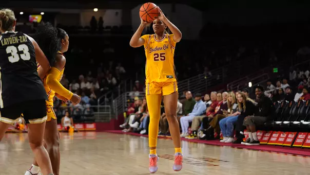 Kara Dunn shooting the basketball in a gold jersey