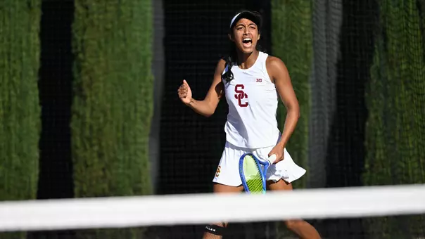 Krisha Mahendran celebrates with a fist pump and yell after beating her tennis opponent