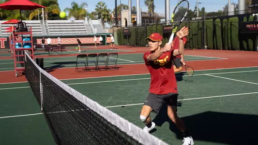 Connor Church hits a shot at the net
