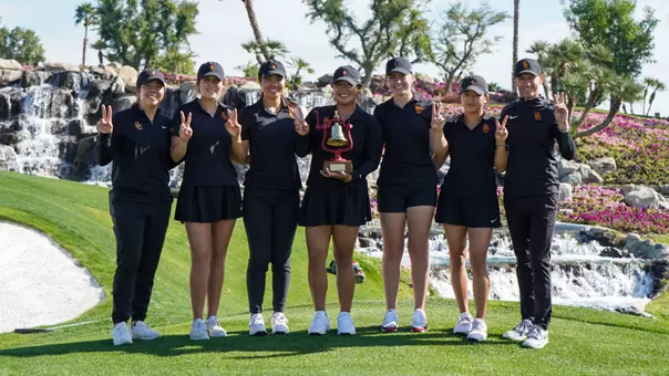 Women's Golf team poses with the Victory Bell after winning the 2026 Battle of LA