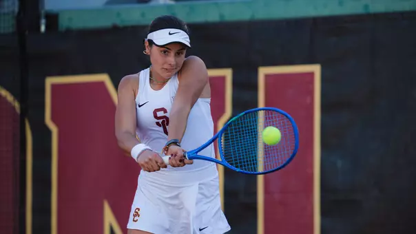 Eugenia Zozaya hits a tennis ball using a racquet.