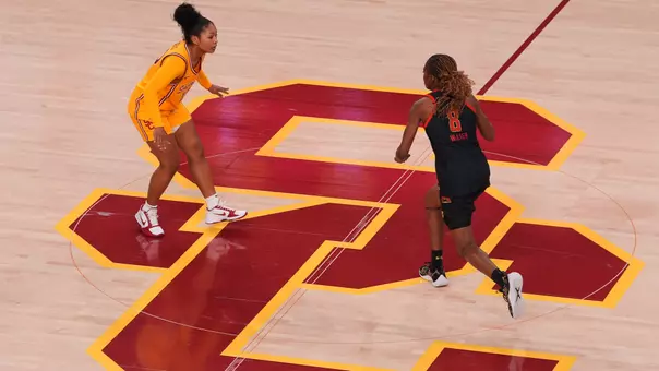 Malia Samuels against a defender on the basketball court.