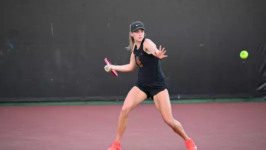 Immi Haddad hits a forehand on the tennis court