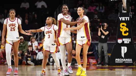 Trojans Celebrate after beating Iowa state on court.