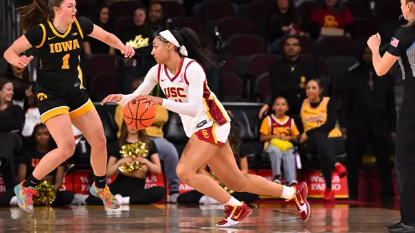 Kennedy smith dribbles the basketball as she drives on court.