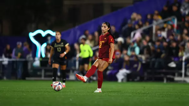 Alyssa Gonzalez kicks the ball on the road at Washington.
