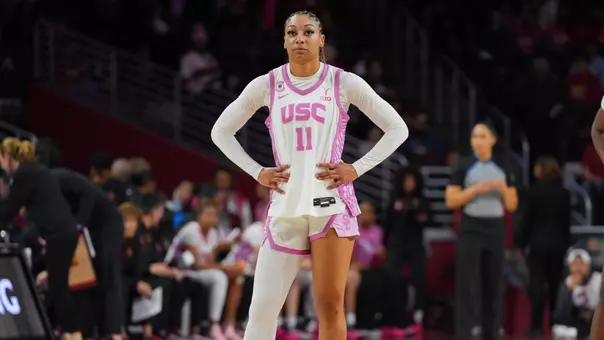 Kennedy smith stands with hands on hips on court.