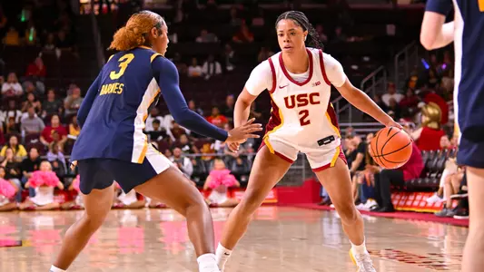 Saniyah Hall on court going with ball in her hand.