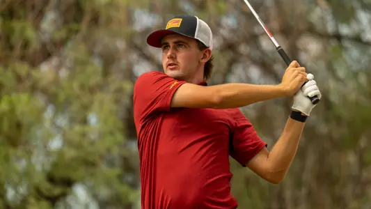Jack Buchanan swings a club at the Bombs Darts Birds Collegiate
