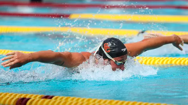 Sanberk Oktar lifts his arms out of the water while swimming.