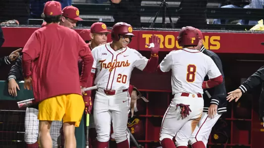 Isaac Cadena and Kevin Takeuchi high five after Kevin scores a run against Pepperdine.