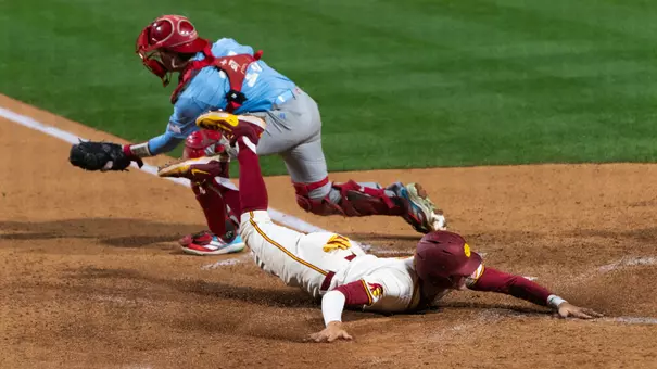 Dean Carpentier slides into home plate in game against LMU.