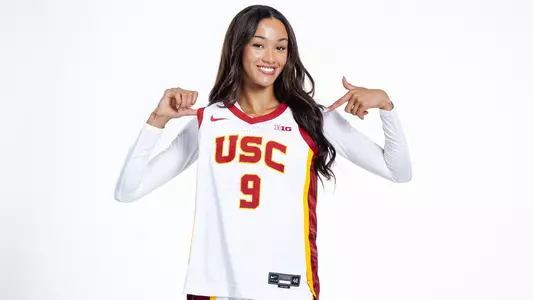 Jazzy Davidson holds up her jersey and points to it.