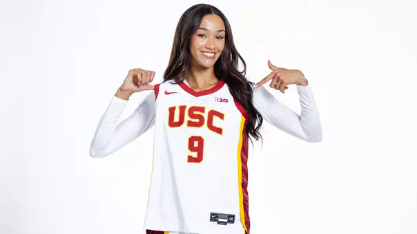 Jazzy Davidson holds up her jersey and points to it.