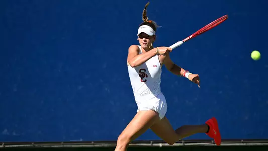 Immi had dad hits a return while competing on court