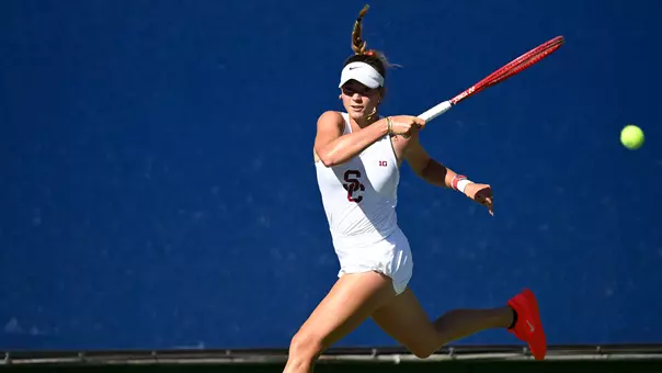 Immi had dad hits a return while competing on court