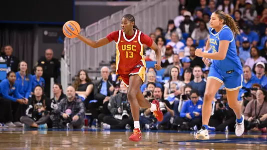 Dayana Mendes dribbles the basketball against UCLA women's basketball player