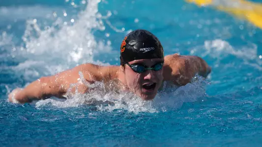 USC men’s swimming and diving athlete racing in a pool during a meet vs. UNLV