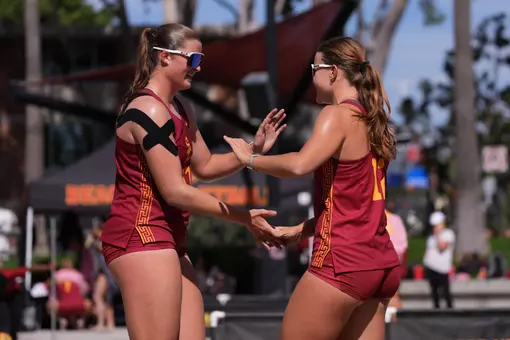 Zoey Henson and Sarah Wood high five after winning a point
