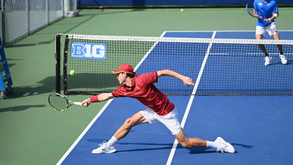 Men's Tennis Player goes for a ball