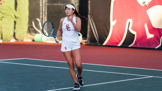 Simone Kay fist pumps in celebration after a win on court.