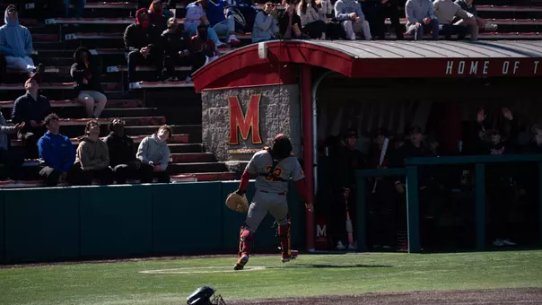 Richard Tejeda runs to catch a foul ball during the Trojans' game at Maryland.