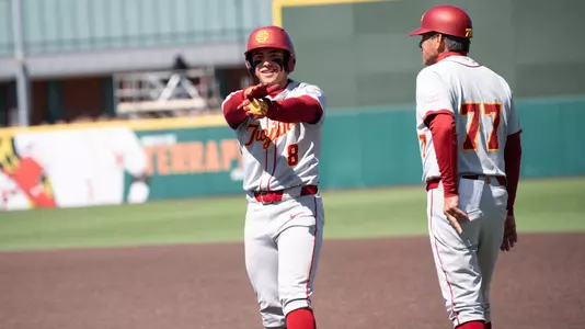 Kevin Takeuchi celebrates on base as he gets his first hit of the series against Maryland.