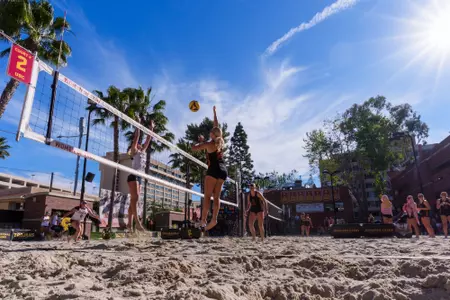 Kaileigh Truslow hits a ball over the net against Pepperdine