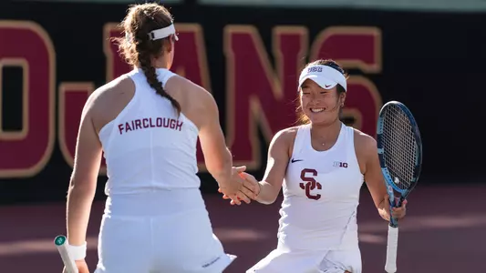 simone kay and lily fairclough high five on tennis court