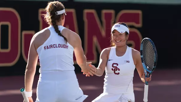 simone kay and lily fairclough high five on tennis court