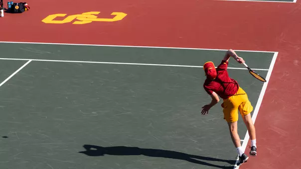 Max Exsted prepares an overhead serve