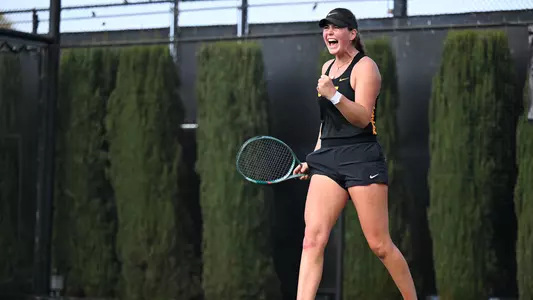 Lily Fairclough celebrates after winning a point on court.