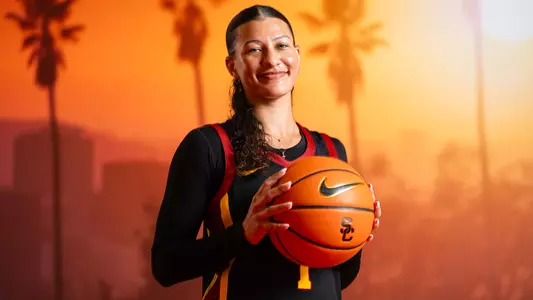 ryann bennett holds up a basketball