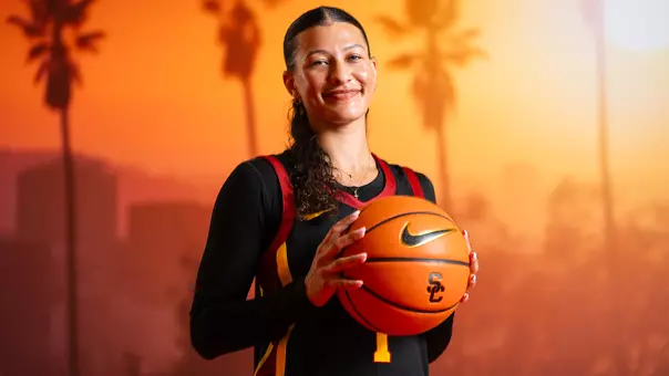 ryann bennett holds up a basketball
