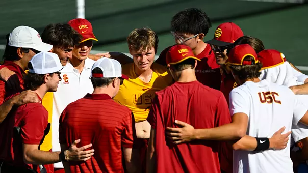 Men's Tennis huddles after a loss on court
