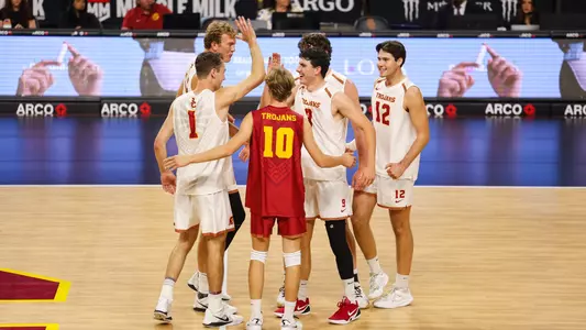 USC men's volleyball huddles and celebrates midcourt at Galen Center