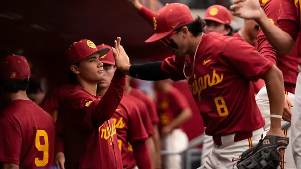 Kevin Takeuchi, Alaka'i Kiakona high five in the dugout.
