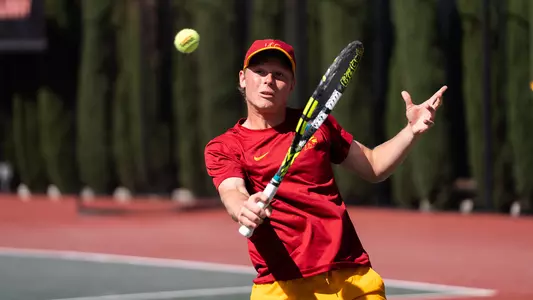 Max exsted hits a backhand with his tennis racket.