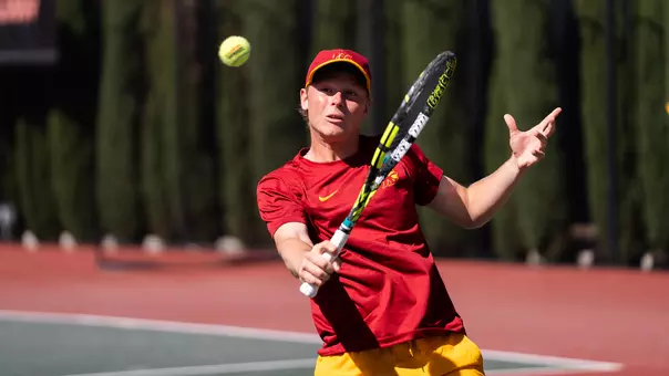 Max exsted hits a backhand with his tennis racket.