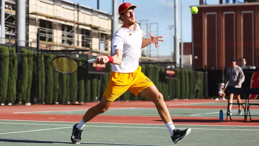 Branko Djuric hits a tennis ball with the racket on a forehand