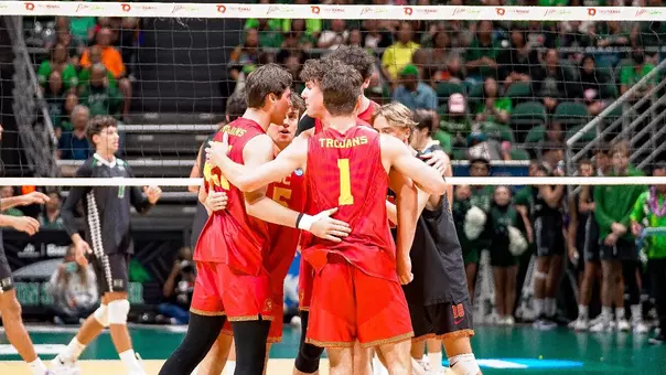USC men's volleyball huddles at midcourt in Bankoh Arena at Stan Sheriff Center in Honolulu