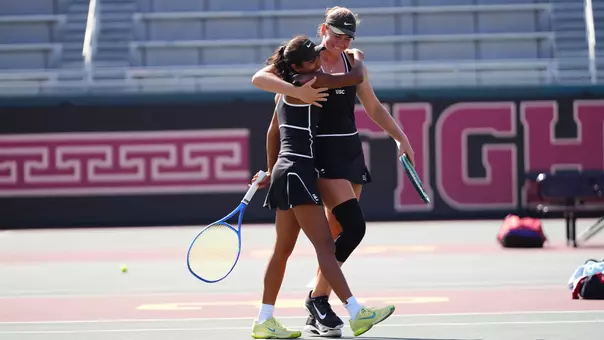 lily fairclough and krisha mahendran hug after playing doubles