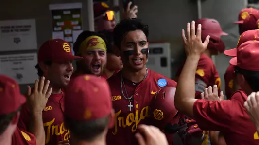 Adrian Lopez celebrates with teammates in the dugout after lead-off home run against Lamar University.