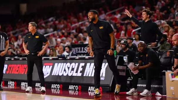 Will Conroy stands by the bench during USC Men's Basketball's game against Nebraska