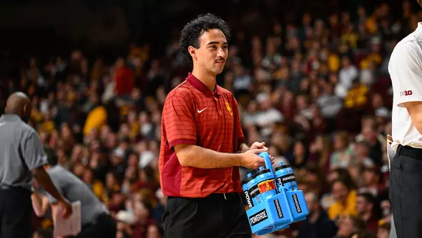 USC men's basketball manager Brady Beyer carries water during a game at Minnesota