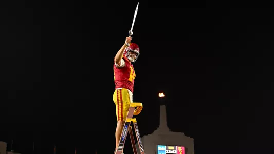 USC Trojans Football quarterback Jayden Maiava leads marching band with sword