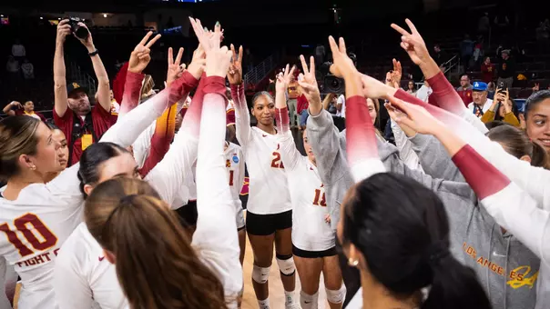 USC women's volleyball players huddle to cheer after a win over Princeton in the first round of the NCAA tournament at Galen Center