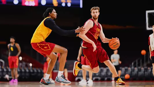 Joshua Hughes dribbles around a defender during a summer basketball practice