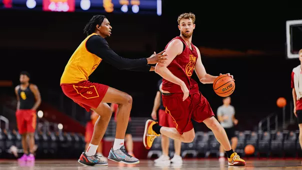 Joshua Hughes dribbles around a defender during a summer basketball practice