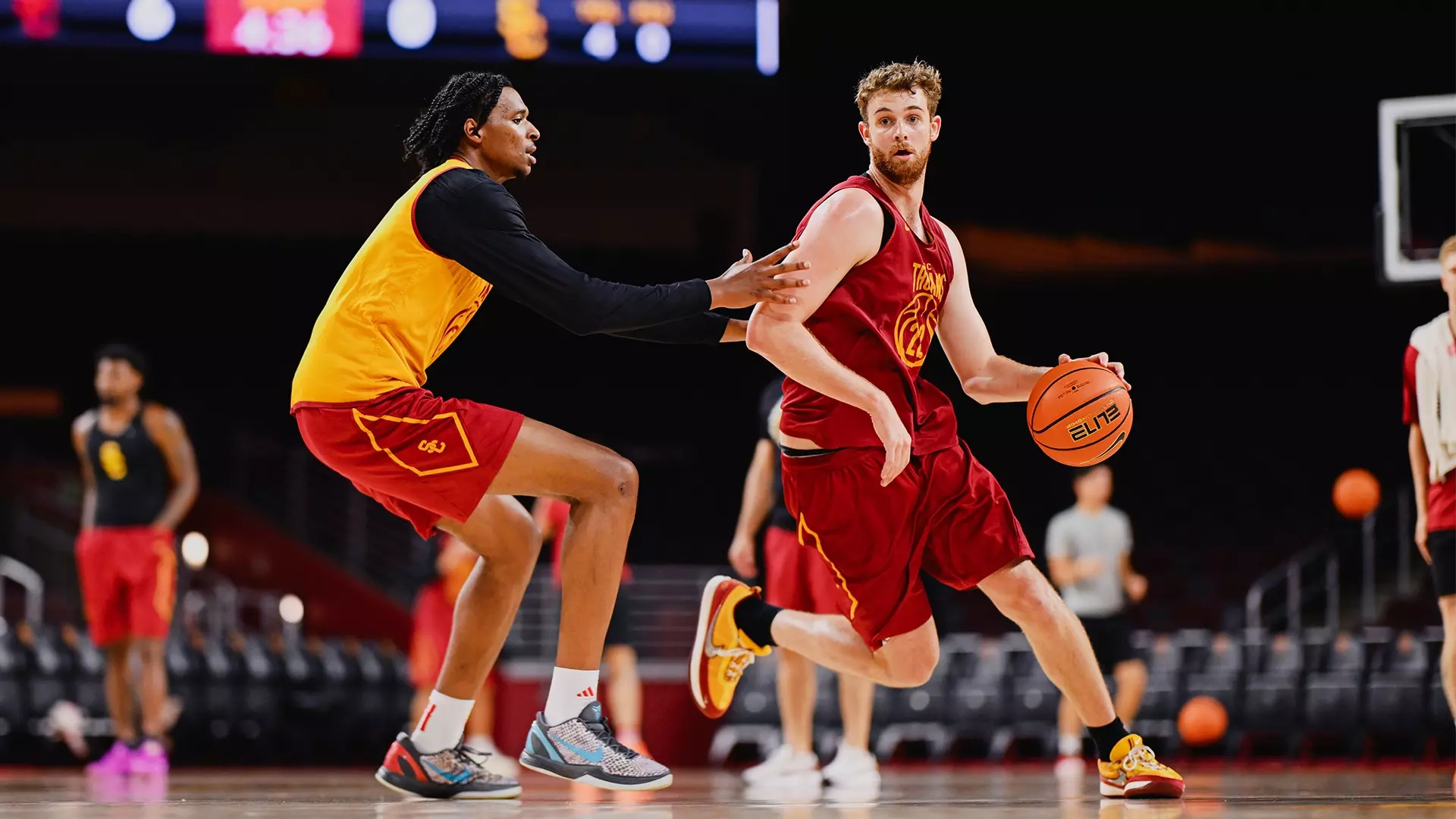 Joshua Hughes dribbles around a defender during a summer basketball practice